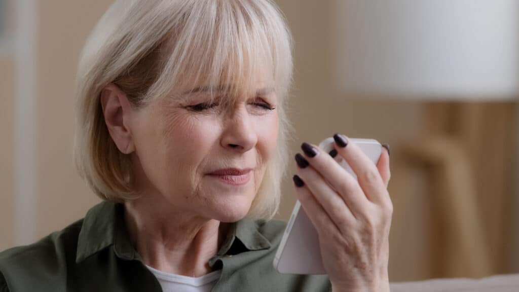 Older woman experiencing blurry vision symptoms of AMD Older woman experiencing blurry vision symptoms of AMD