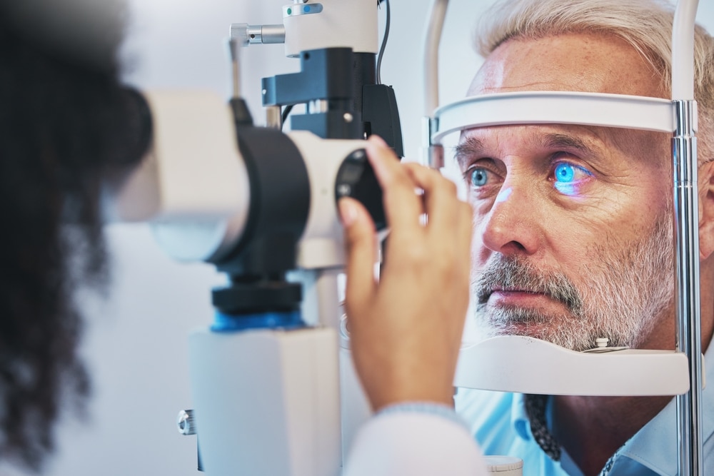 An adult man undergoing a glaucoma eye exam with an eye doctor. An adult man undergoing a glaucoma eye exam with an eye doctor.