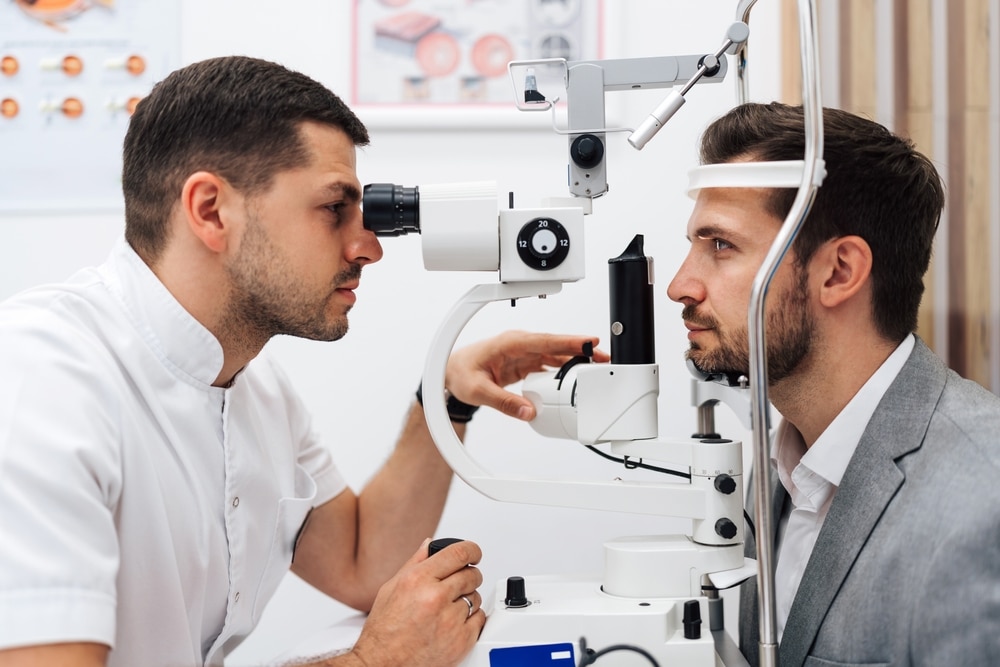 Eye doctor performing a diabetic eye exam on a woman in a clinic. Eye doctor performing a diabetic eye exam on a woman in a clinic.